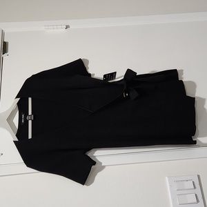 Vneck crossover sweater with tie on left side. Tye is tacked into place.